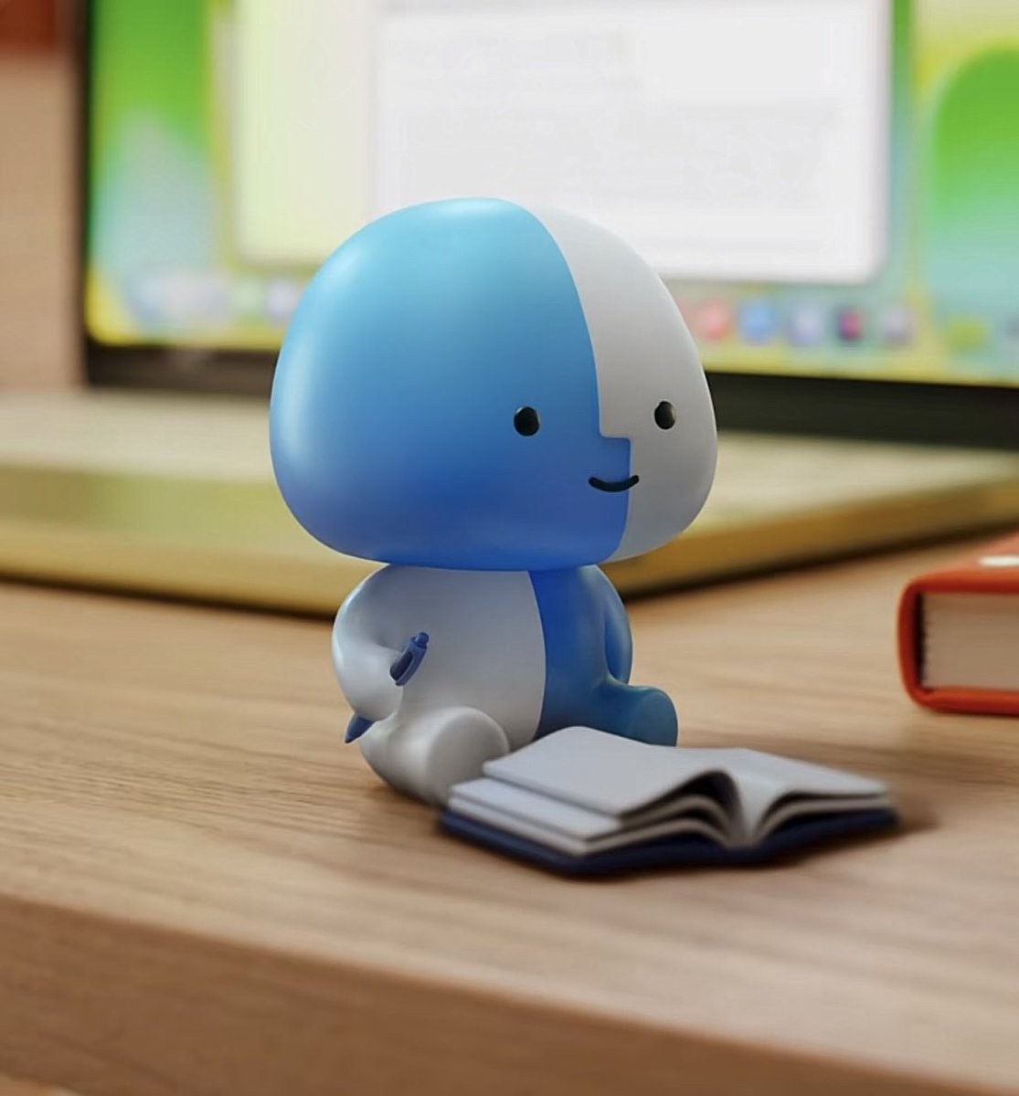 Lil Finder Guy sitting with a tiny open book